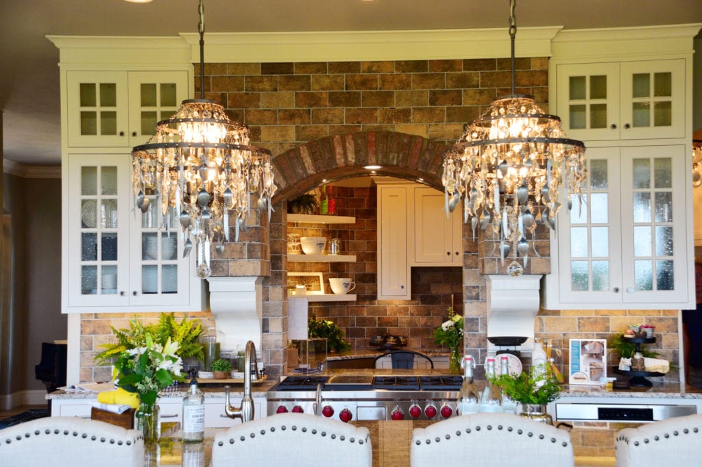 A beautiful kitchen with two chandeliers