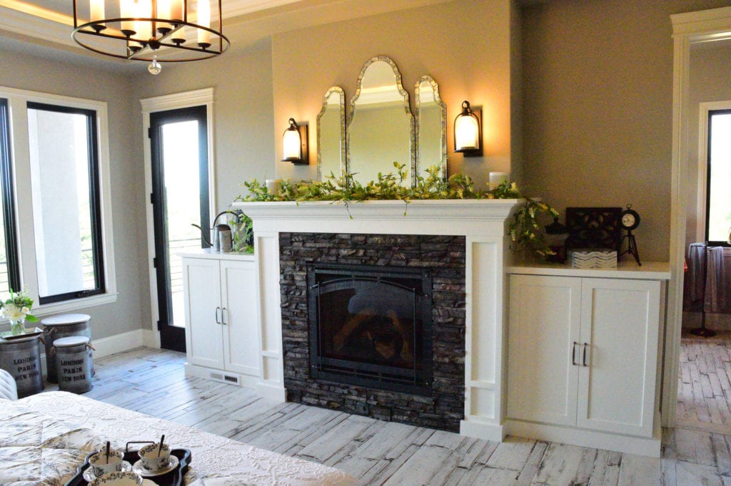 A fireplace with two cabinets on the side