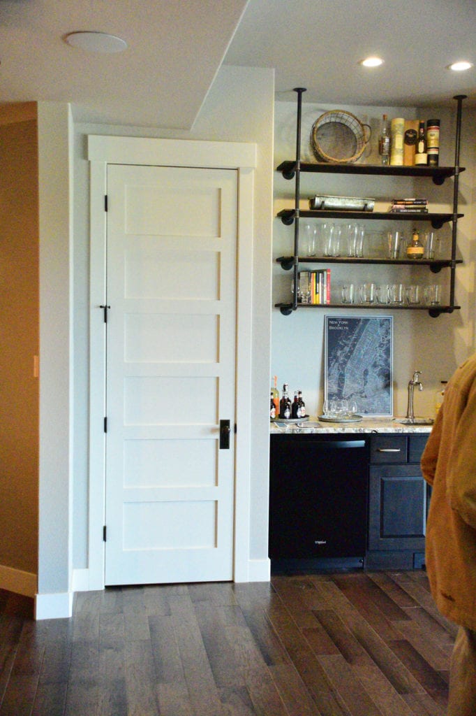 A white door and hanging shelves